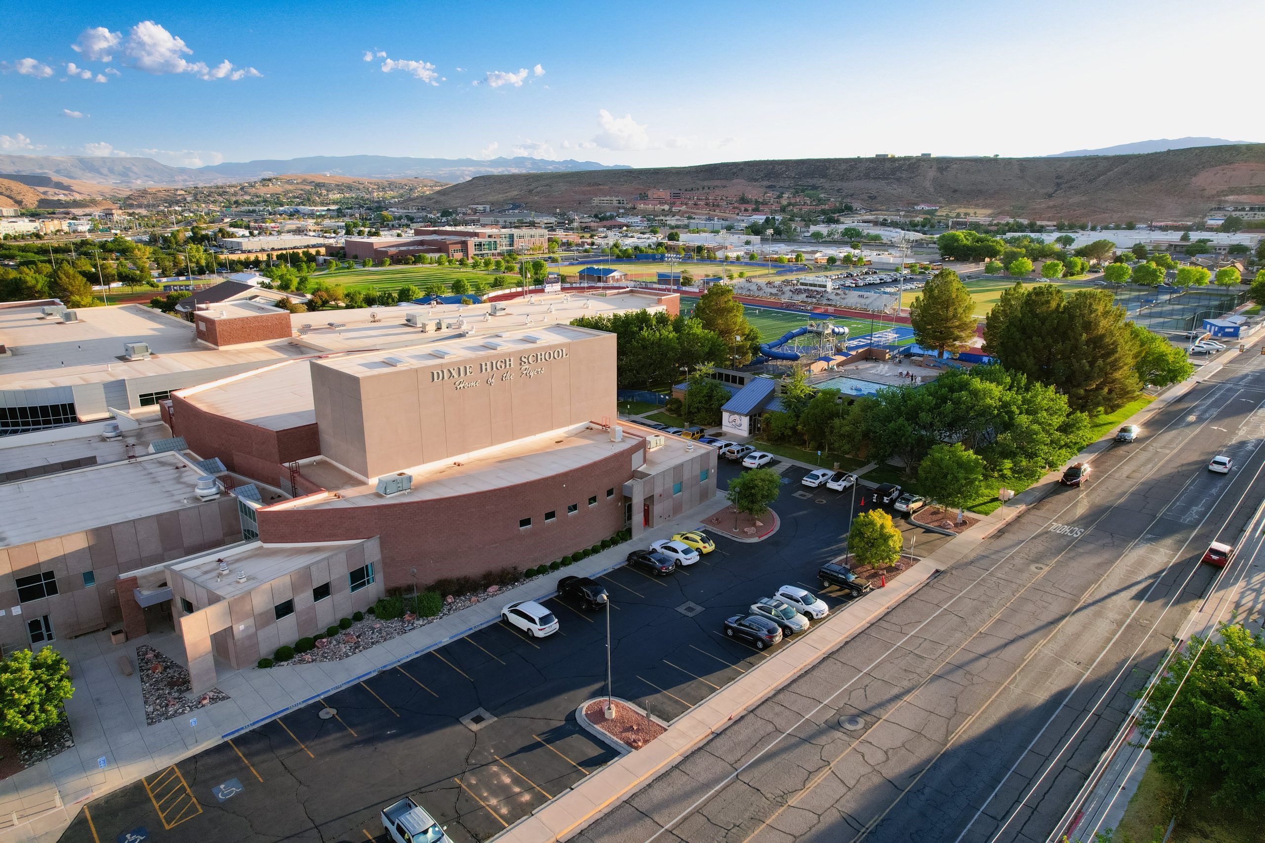 Arial view of the campus from the north with buildings and hills in the background