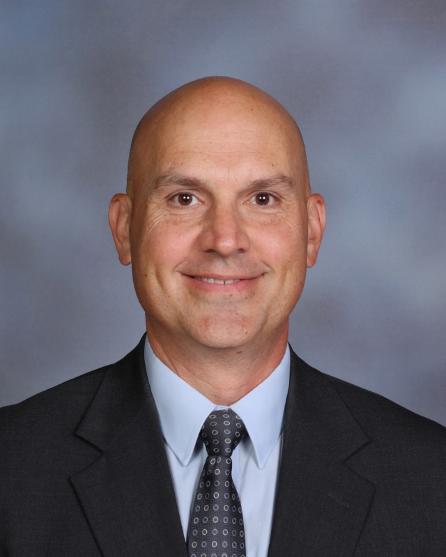 Picture of Ryan McConnel wearing a suit and tie.